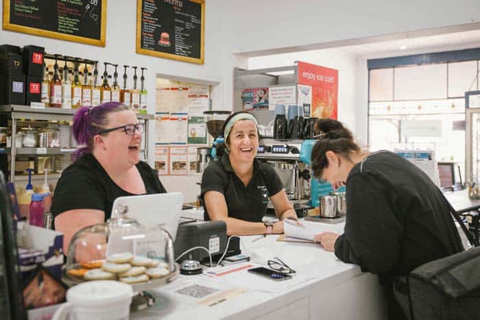 Staff members at a cafe in Bruce Rock laughing with customer