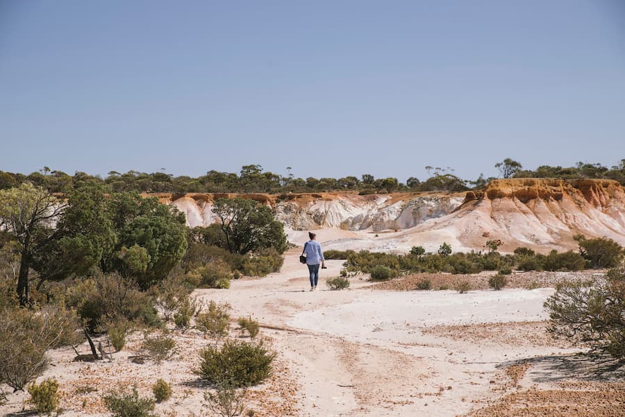 Image of women walking track in Buckleys Breakaway, with white cliffs and underlying clay in Kulin