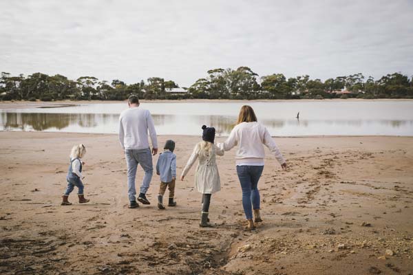 Image of a young family walking towards a lake in Narembeen