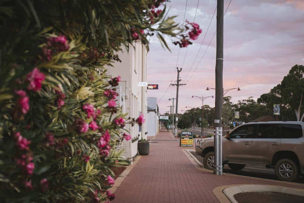Image of the footpath heading down the main street in Corrigin with the hotel sign