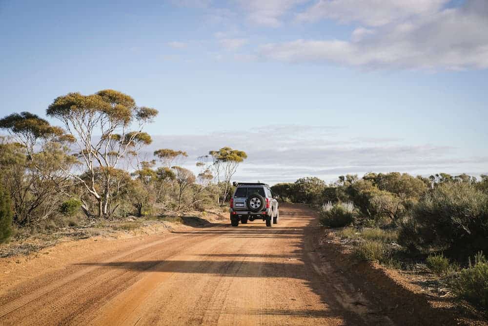Image of 4WD vehicle driving down pathway on trail